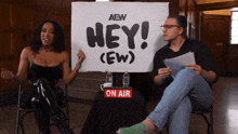 a woman is holding a sign that says hey ew