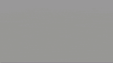 a pixelated image of a man wearing a purple shirt and a hat