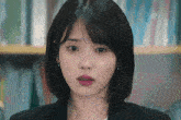 a close up of a woman 's face with a shocked look on her face