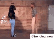 a man and a woman are standing next to each other in a room with a hashtag that says trendingnnow