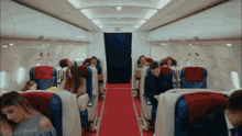 a group of people are sitting on an airplane with the word nm on the seat
