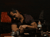a man playing poker with a bottle of corona beer behind him