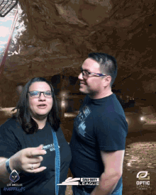 a man and a woman are posing for a photo with a call of duty league logo in the background