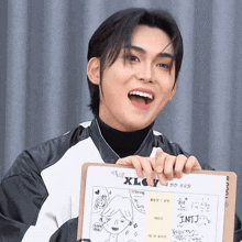 a young man holding a clipboard that says xlcv