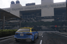 a taxi is parked in front of a building that says los santos international airport