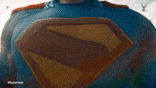 a man in a superman costume is standing in front of a city skyline