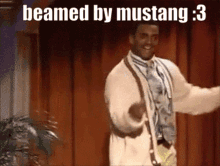 a man is dancing in front of a red curtain with the words beamed by mustang : 3