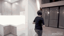 a woman in a black shirt is walking down a hallway with the words made in animotica on the bottom