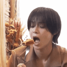 a woman eating a piece of food with a fork in her mouth