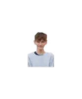 a young boy in a blue sweater is smiling and looking at the camera .