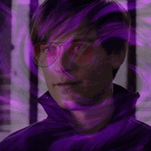a man with purple hair and red glasses is surrounded by purple lights