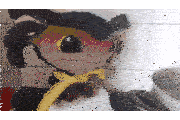 a stuffed animal with a yellow scarf around its neck is sitting on top of a blender .