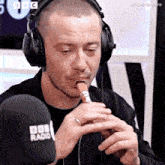 a man wearing headphones and a bbc radio microphone
