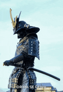 a statue of a samurai holding a sword with the words dr hase gewa below him