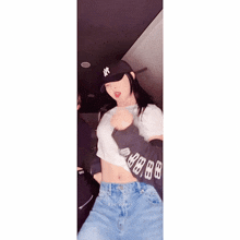 a woman wearing a ny hat is dancing