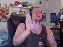 a man wearing headphones is sitting in a chair with his eyes closed