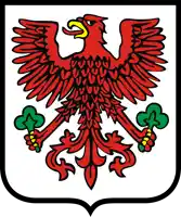 a red eagle with a yellow beak is on a shield