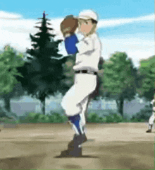 a baseball player in a white uniform is standing on a field with trees in the background .