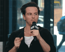 a man speaking into a microphone with the word build on it