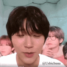 a close up of a person 's face with the name ushichuuu on the bottom
