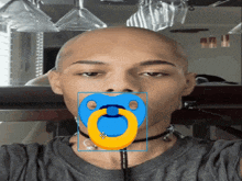 a man with a pacifier in his mouth is wearing a choker around his neck