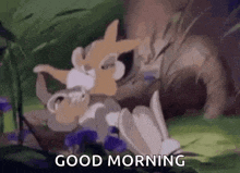 a couple of rabbits laying on top of each other in the grass with the words `` good morning '' written on the bottom .