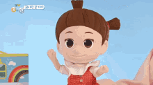 a person is holding a doll with a red dress