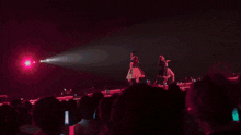 two women in blue dresses are dancing on a stage