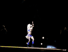a blurred image of a woman singing into a microphone with the words rbd.gif below her