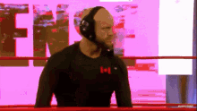 a man wearing headphones is standing in a boxing ring with the word free in the background