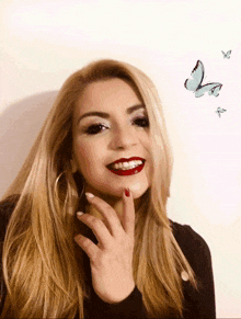 a woman is smiling with butterflies flying in the background
