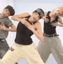 a group of people are dancing and one of them has the letter b on his pants