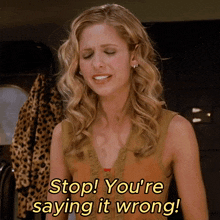 a woman says " stop you 're saying it wrong " in yellow letters