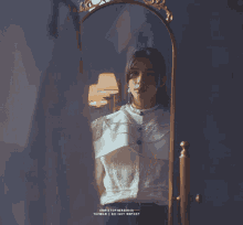 a woman in a white shirt is looking at herself in a mirror with the words tumblr do not repost