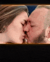 a man and a woman are kissing in a frame that says ' ucru ' on it