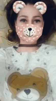 a woman wearing a teddy bear face mask