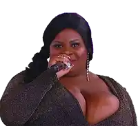 a woman with very large breasts is holding a microphone to her mouth .