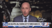 a man in a suit and tie stands in front of a fox news channel banner