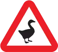 a red and white triangle sign with a black duck on it