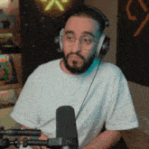a man with a beard wearing headphones and a t-shirt that says ' i love you ' on it