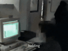 a blurred image of a computer with the word holding visible