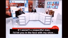 a group of men are sitting at a table in front of a sign that says memri tv on it