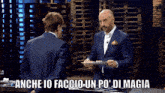 a man in a suit is giving another man a plate of food with the caption anche io faccio un po