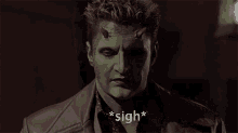 a man with green face paint and horns has the word sigh above his head