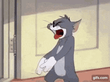 a cartoon cat is yawning while walking down a hallway next to a door .