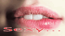 a close up of a woman 's lips with the word sexy written below them