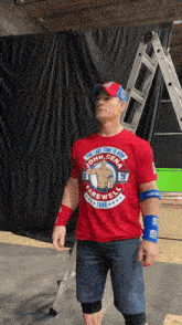 a man is wearing a red shirt that says john cena farewell