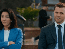 a man and a woman are sitting next to each other with their arms crossed