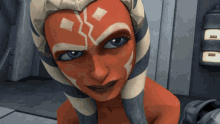 a close up of a cartoon character 's face with a striped headband on