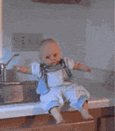 a baby is sitting on a counter with flames coming out of its head